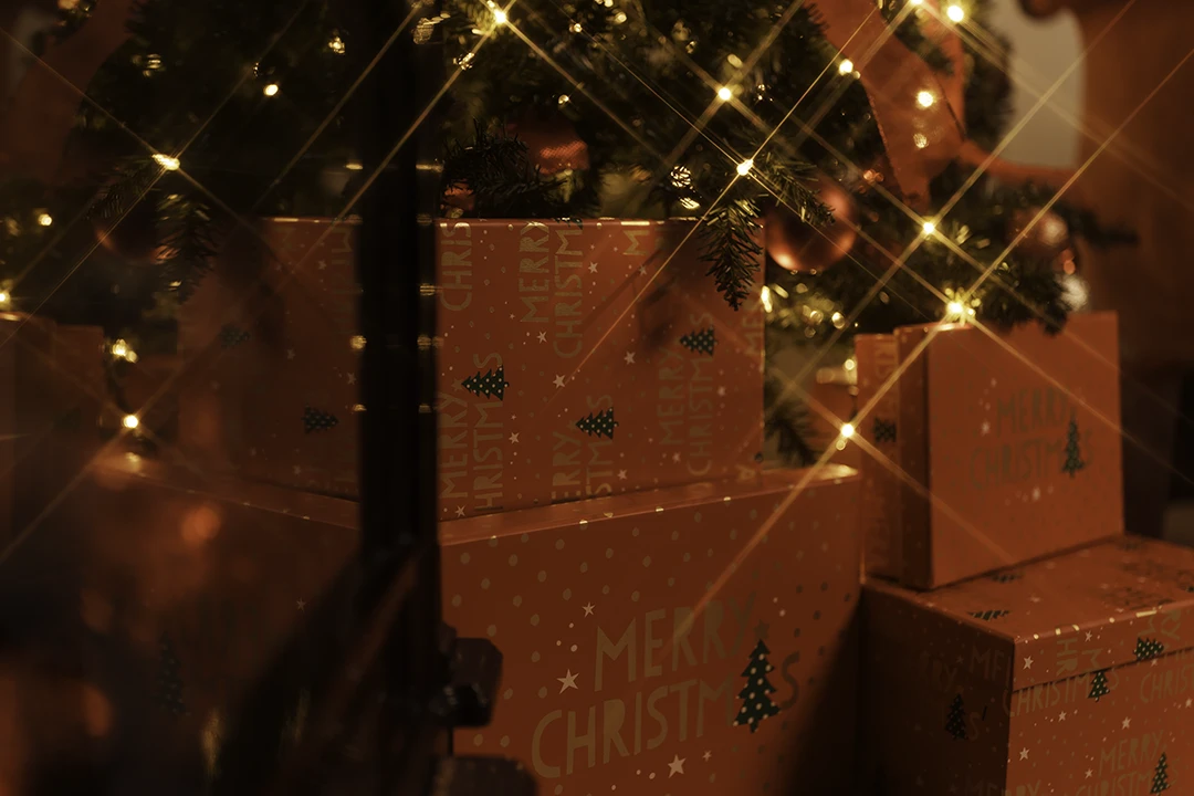 present under a tree with twinkling lights