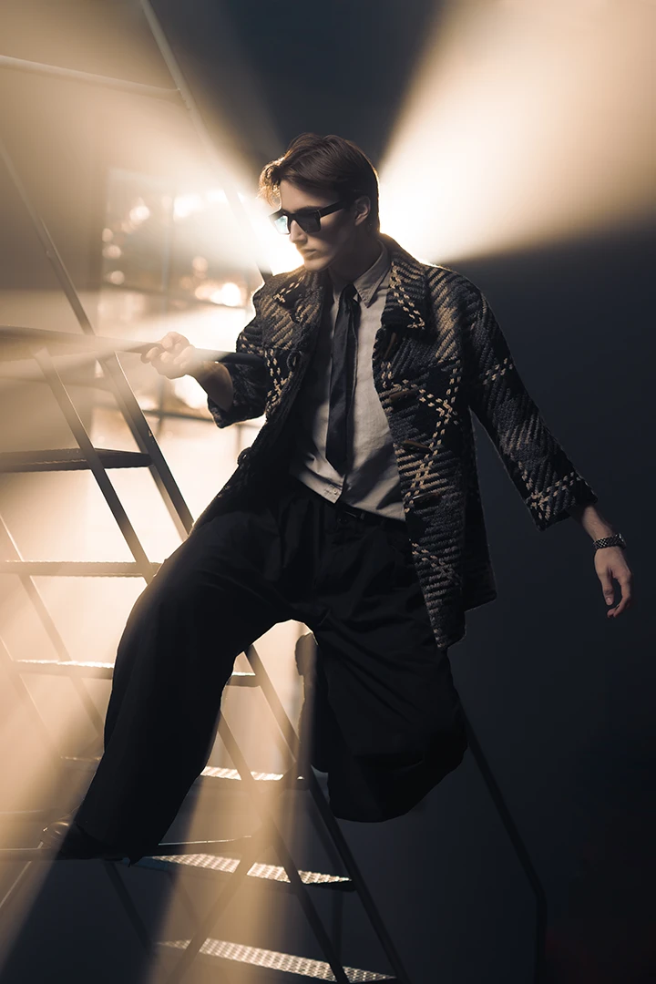 model posing on rolling ladder - camera gear for rent