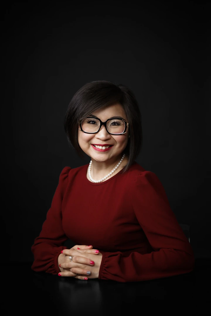 woman posing for headshots on folding table - photography equipment for rent
