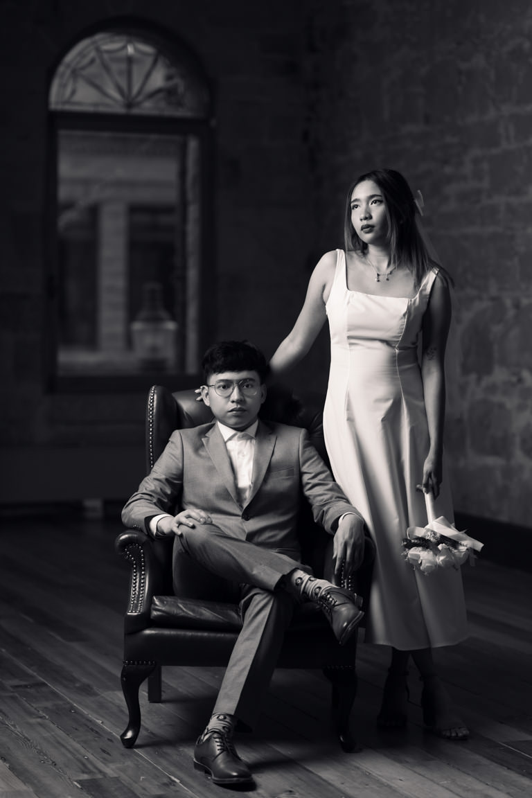 couple posing on wingback chair - photography gear for rent