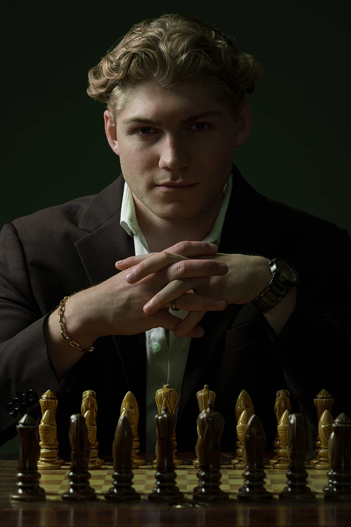 artist portrait of man playing chess - photo studio