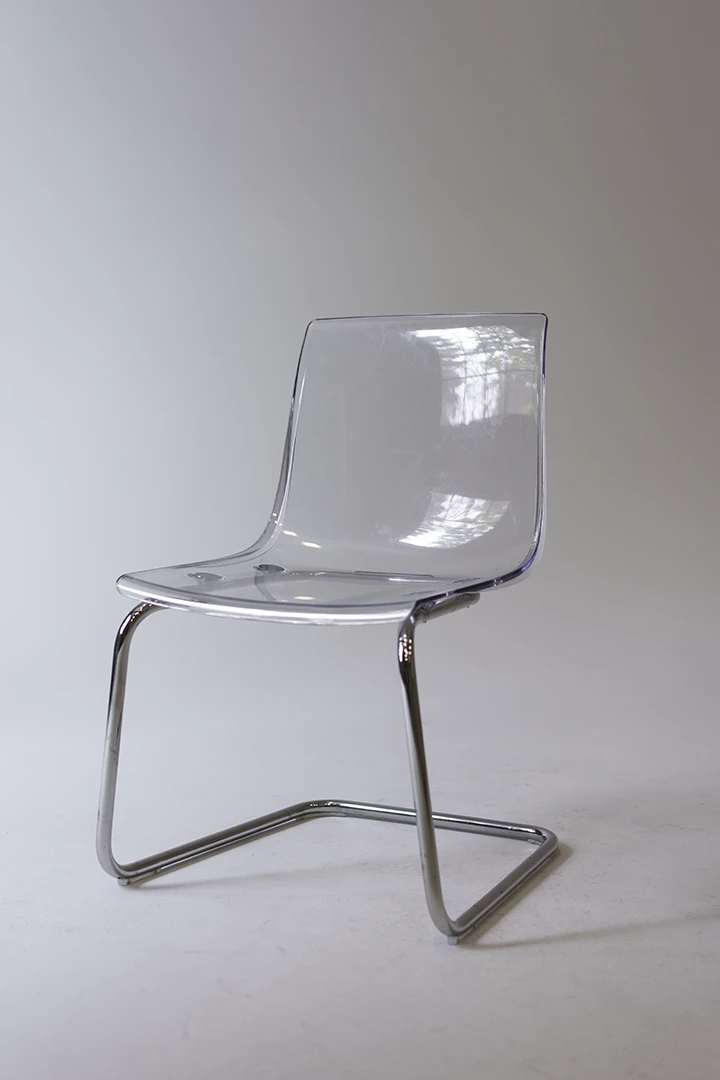 clear chair on cyc wall at photo studio in Cagary
